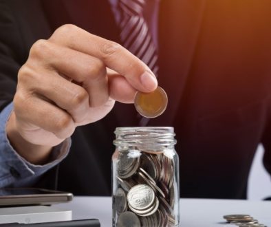 hand-putting-mix-coins-seed-clear-bottle-copyspace-business-investment-growth-concept